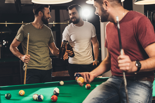 friends playing pool, drinking beer